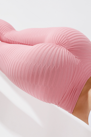Close up of girl holding plank wearing pink adapt scrunch bum leggings
