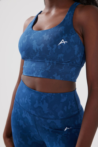 Close up shot of girl wearing legacy sports bra and scrunch bum leggings in blue