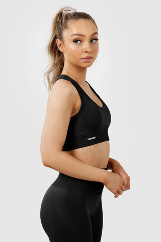 Close up of girl wearing invictus seamless sports bra and leggings in black