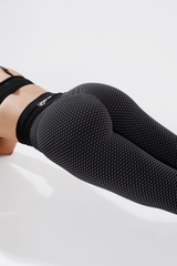 Close up of girl holding plank wearing luna seamless scrunch bum leggings in black