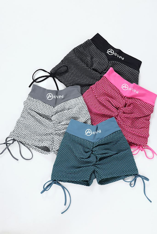 Luna scrunch bum shorts in blue, black, grey and pink laid on floor in group shot