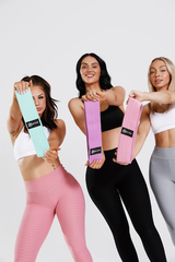 Girls holding resistance bands out infront of them, low, medium and high resistance