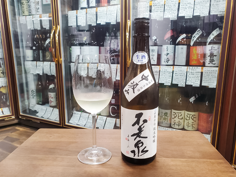 Image of pouring unfiltered raw unprocessed sake into a wine glass