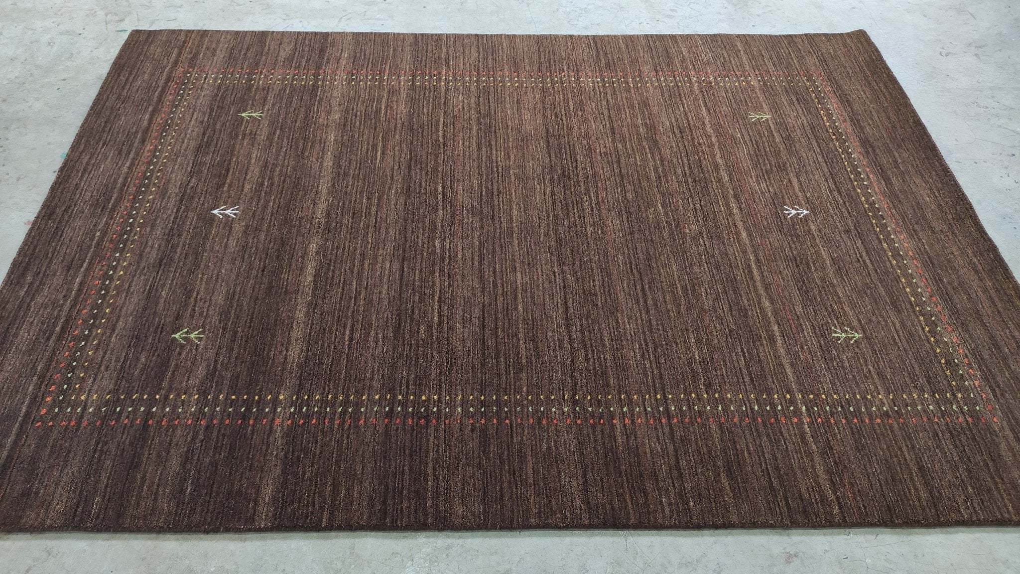 https://cdn.shopify.com/s/files/1/0257/9169/2836/products/5x7-brown-handwoven-gabbeh-rug-118803.jpg?v=1692008750