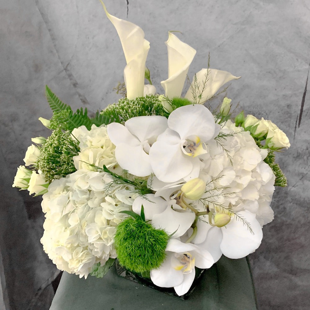 Mix of white hydrangeas, orchids,calla arrangement and roses |PETALINO –  Petalino Flower Bar & Events