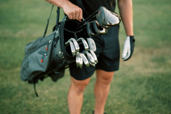 golfer with full set of irons in bag