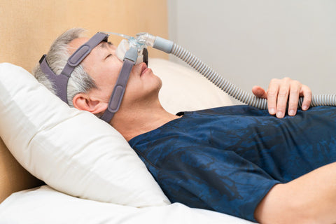 middle aged man wearing CPAP mask