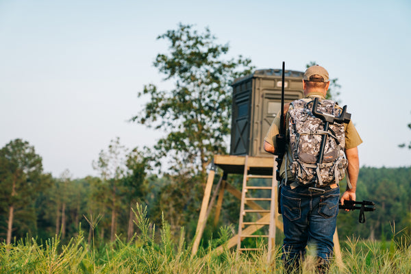 Man walking up to a deer stand with Rear Precision Pod