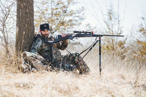 a man using a Rear Precision Pod to keep his gun stable while hunting