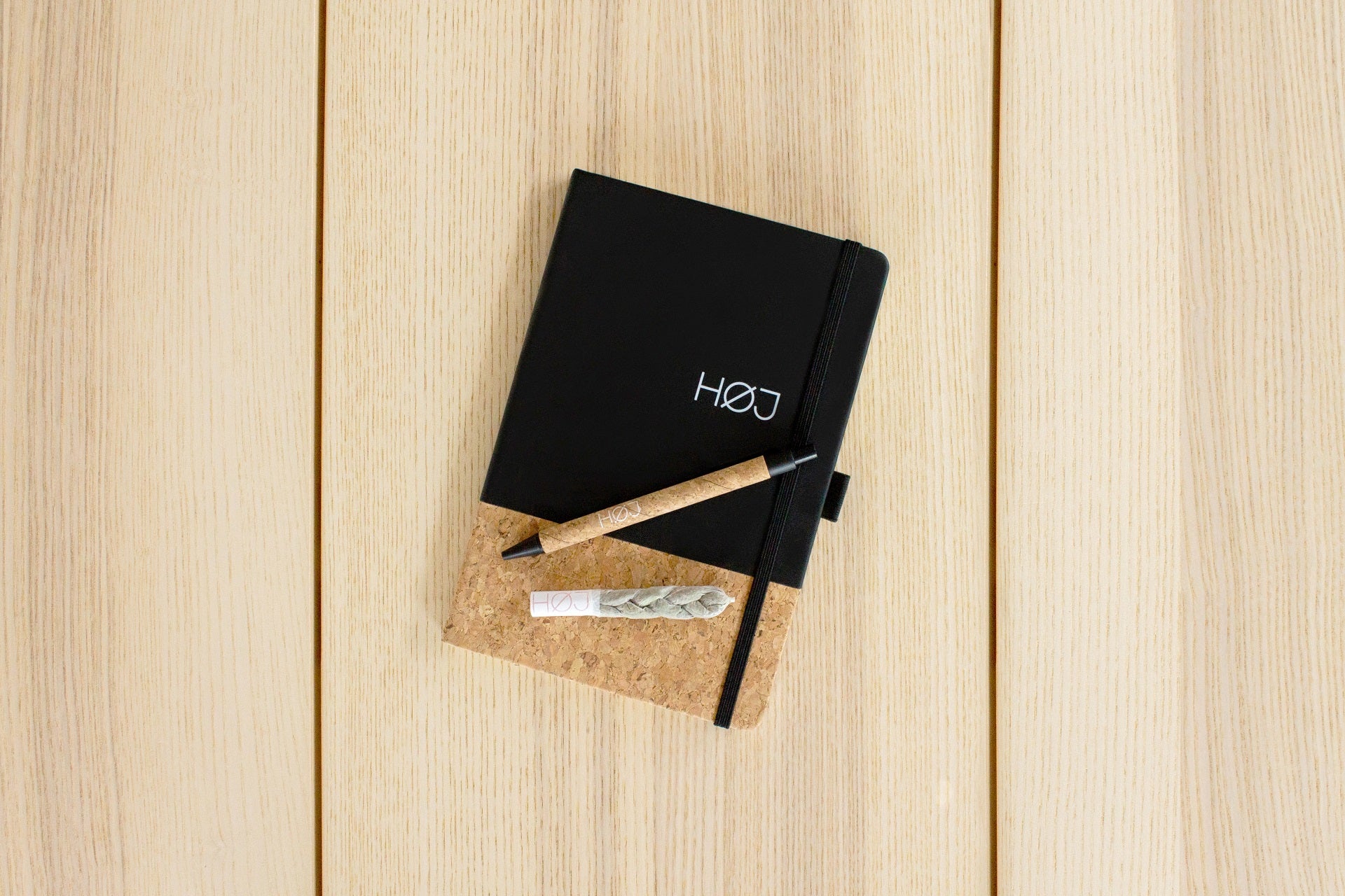 A fancy braided joint on a notebook with a pen