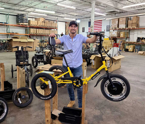 Jason Kraft, CEO of Electric Bike Technologies, stands with a Liberty Trike. Since January, Kraft has gifted 10 electric tricycles to kids with spinal muscular atrophy.