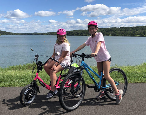 Doylestown's Mckenna Ellixson, left, and her sister Meghan, right, head out for a bike ride at Buck County's Peace Valley Park.
