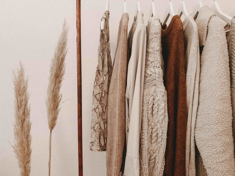 fall fashion with neutral clothes hanging from clothes rack