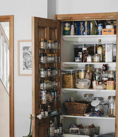 organized kitchen pantry with spices and dry goods on shelves