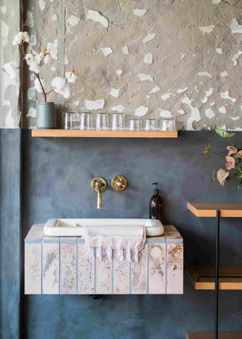 shibui with natural cement wall above bathroom sink