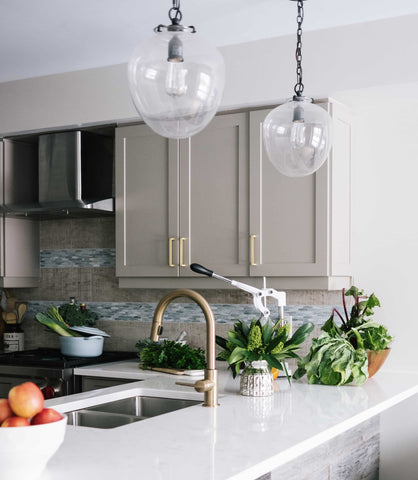 modern farmhouse kitchen with industrial lights and stone counters