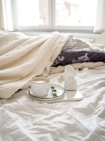 coffee on serving tray in bed for relaxation