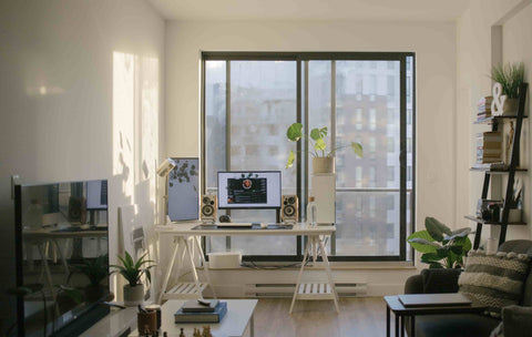 organized condo living room with tv, sofa, computer desk