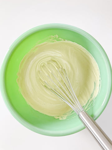 Whisk in yogurt in green bowl