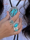 hand holding turquoise bolo tie