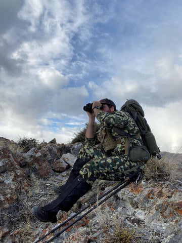 hunter looking through binoculars