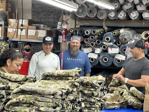 Willie Robertson and Andy Techmanski with workers at FORLOH factory