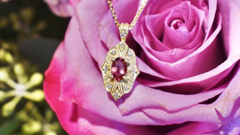 yellow gold pendant set with a pink tourmaline on a rose