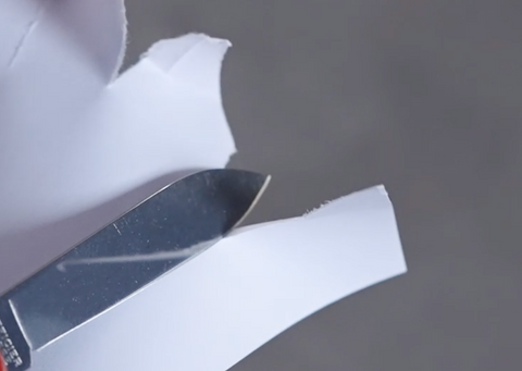 Test the sharpness of your knife blade by cutting a piece of paper.