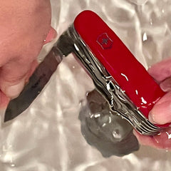 Swish your Swiss Army Knife under warm water to clean.