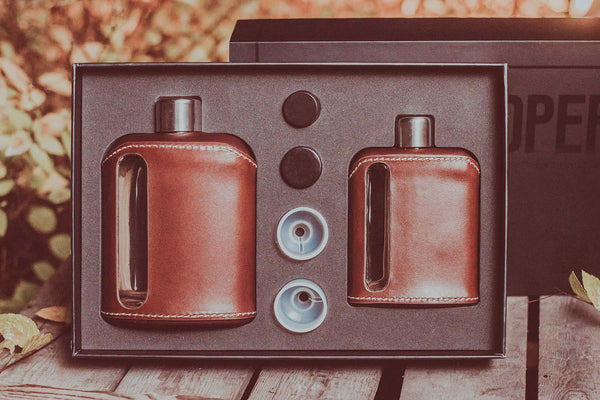 Set of Ragproper glass flasks wrapped with a permanent dark brown leather cover.