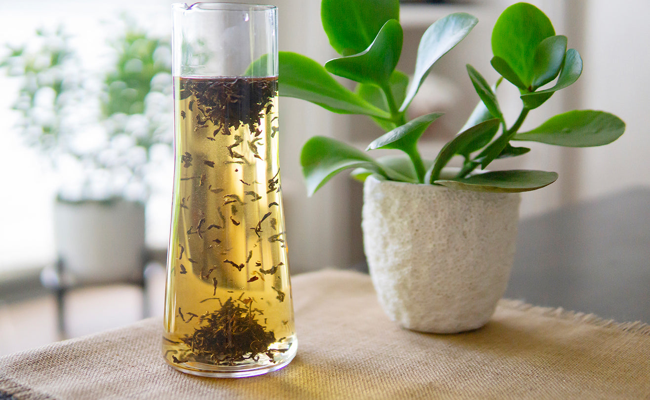 Pitcher of homemade loose-leaf iced tea steeping.