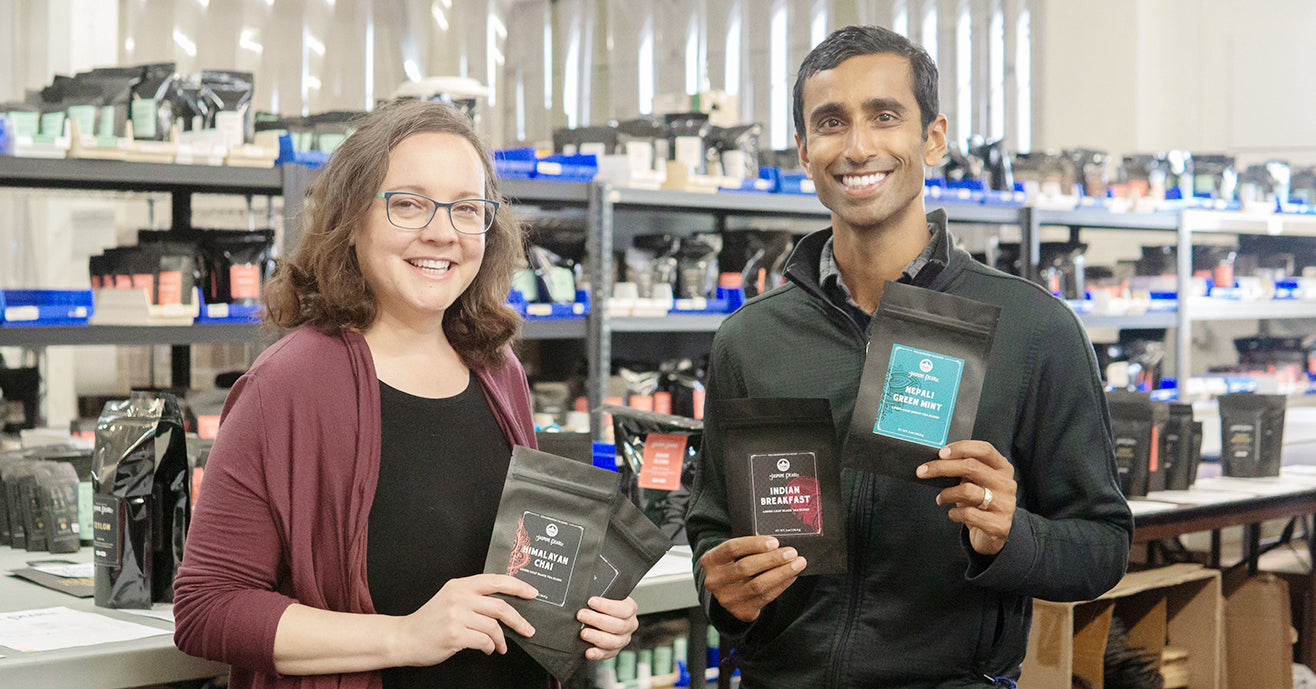 Heather of Jasmine Pearl Tea and Raj of Young Mountain Tea holding the new tea blends and smiling