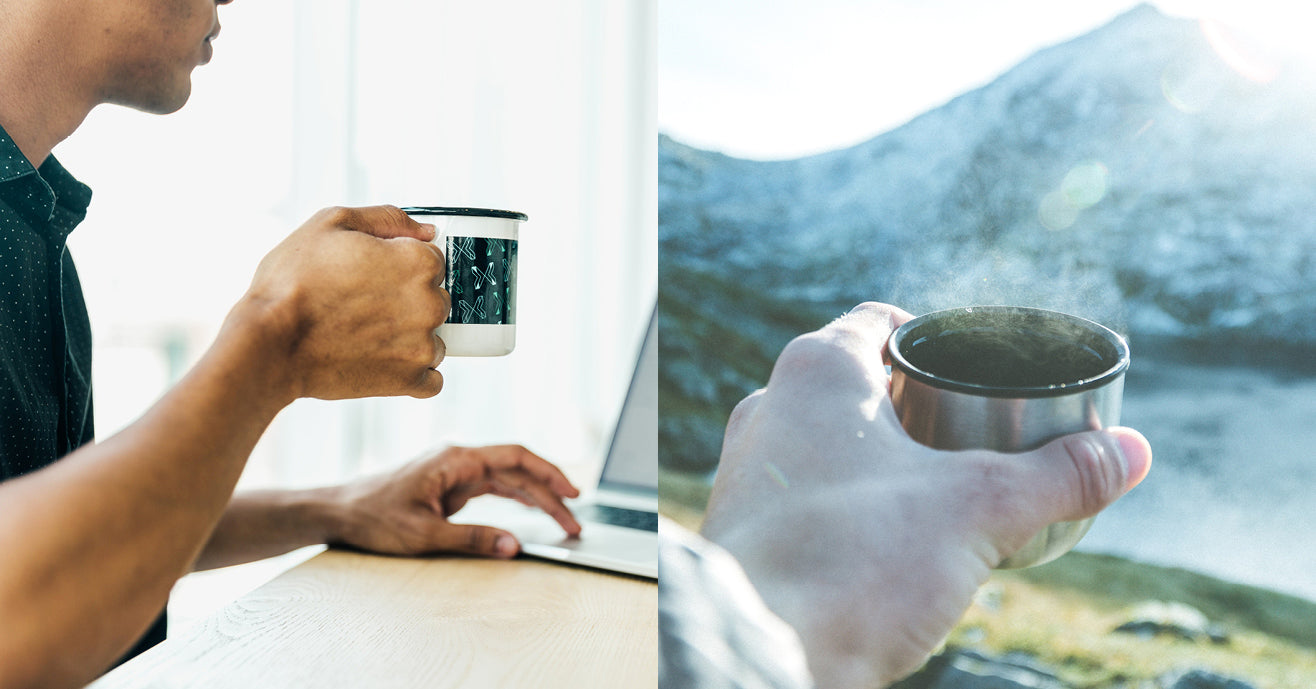 Person holding a mug of coffee and working on the laptop, next to a hand holding a steaming cup of tea against a mountain background.