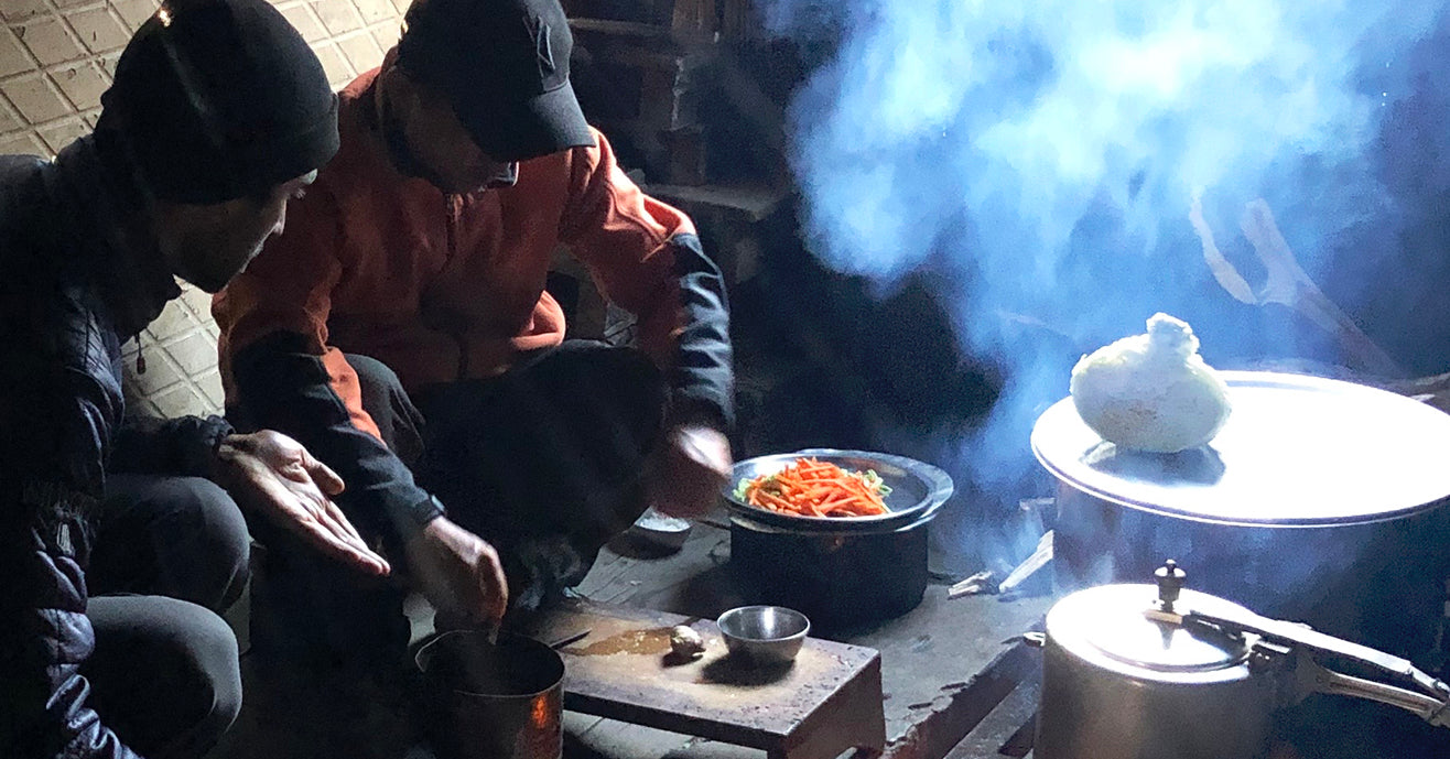 Raj and Passang making dinner in a tea hut while on a trek, Darjeeling, India