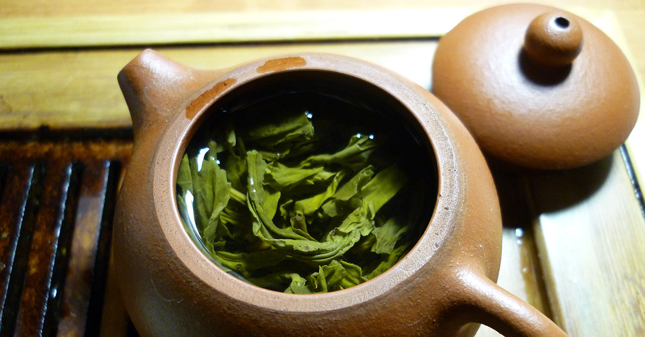 green tea leaves in a gong fu teapot