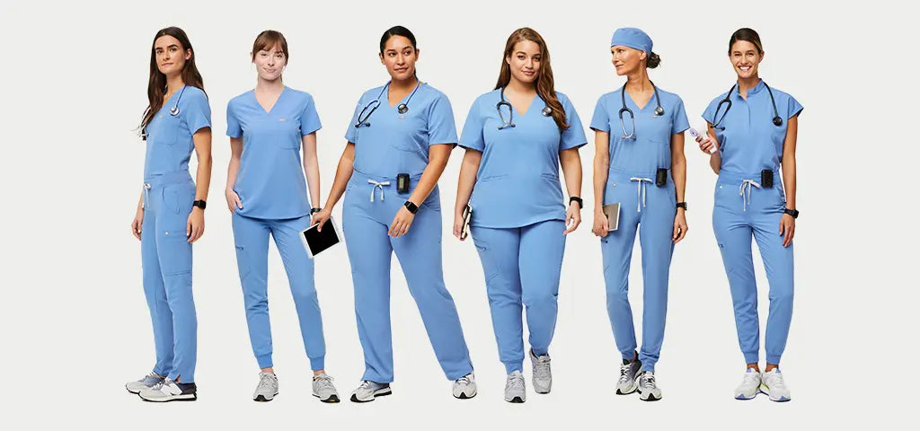 A group of female nurses wearing ceil blue scrub uniforms on a light grey background.
