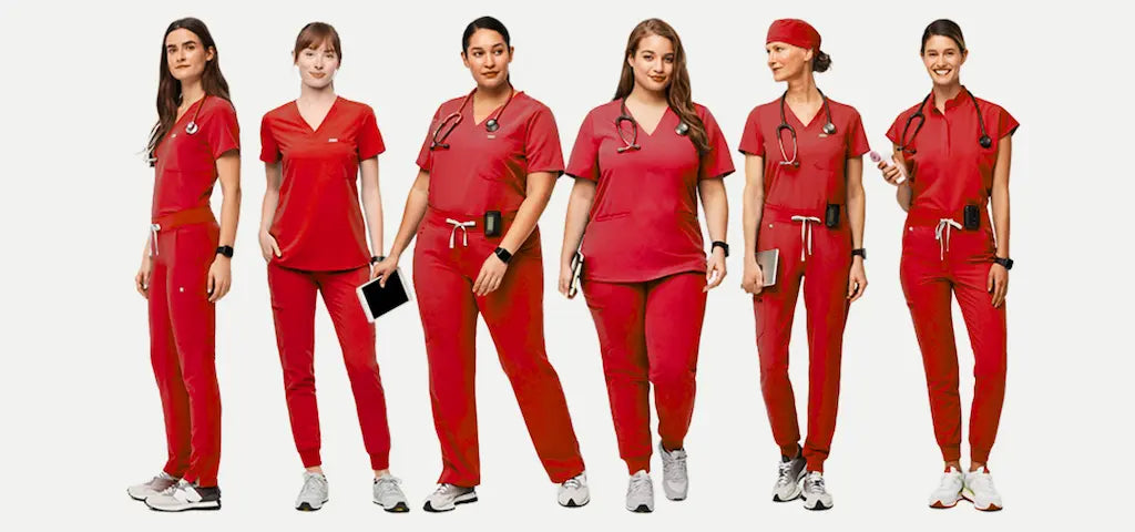 A group of female cardiovascular nurses wearing red scrubs on a white background.