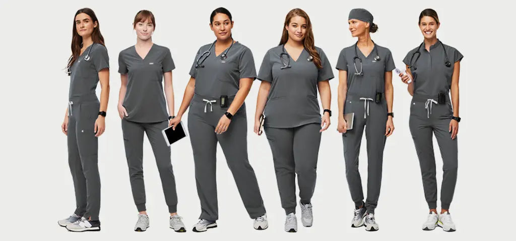 A group of female lab techs wearing Pewter Scrub Uniforms on a light grey background.