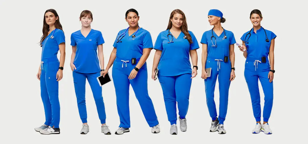 A group of female Physical Therapists wearing Royal Blue scrub uniforms on a white background.