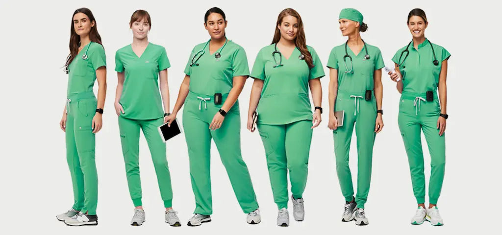 A group of female surgeons wearing Surgical Green medical uniforms on a light grey background.