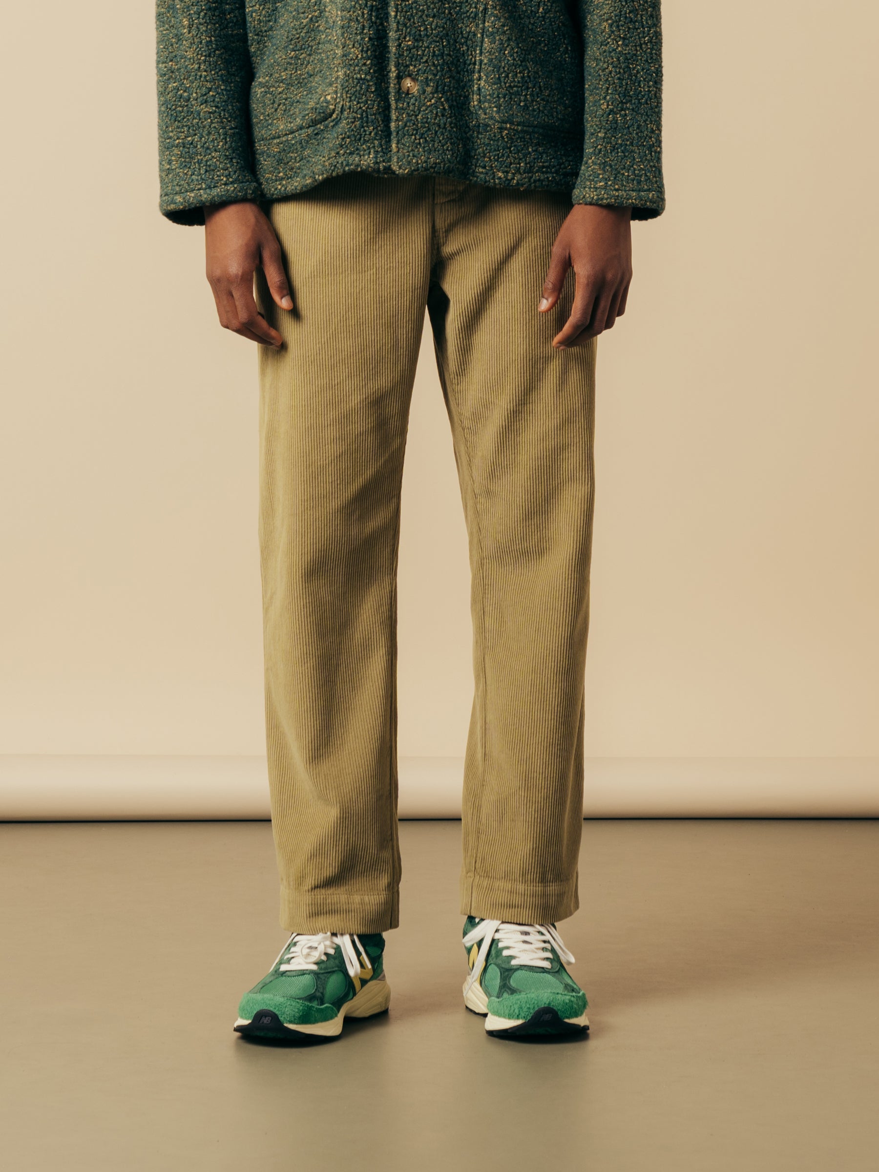 A pair of straight leg workwear pants in a green corduroy.
