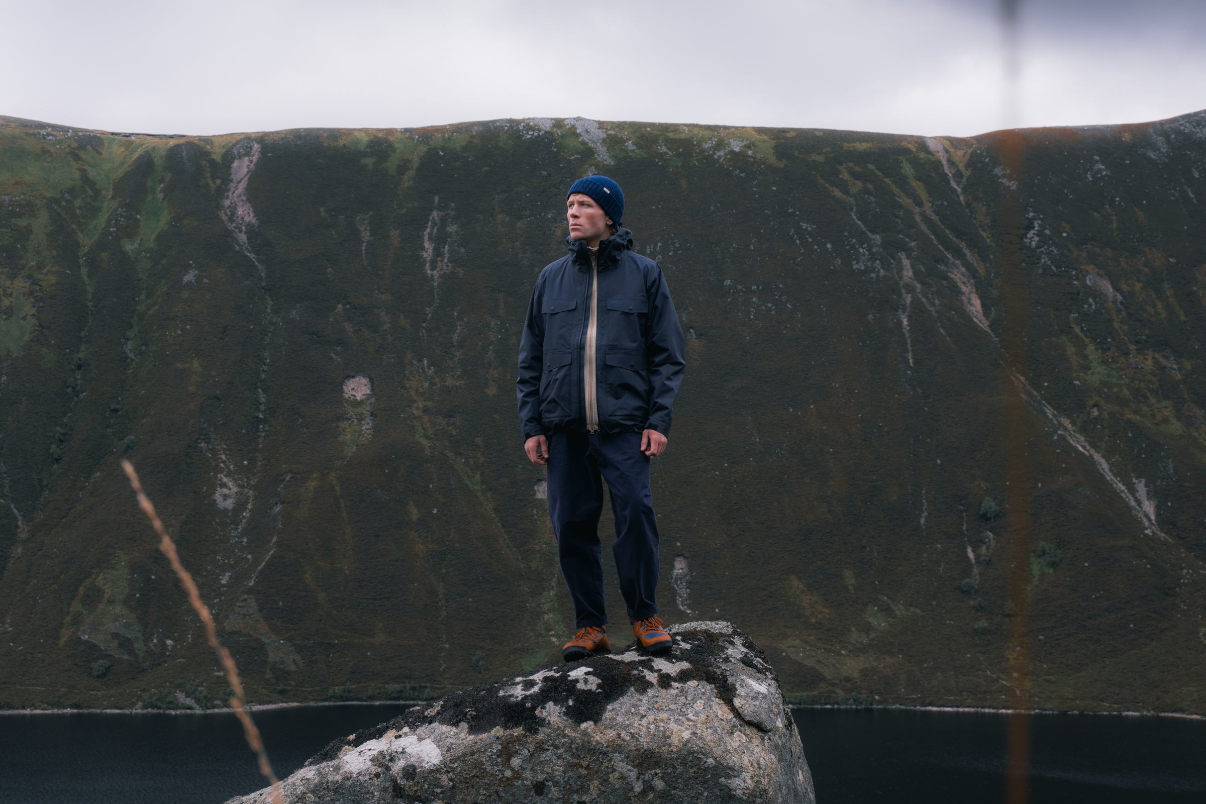 A man wearing a waterproof shell jacket in the Scottish Cairngorms.