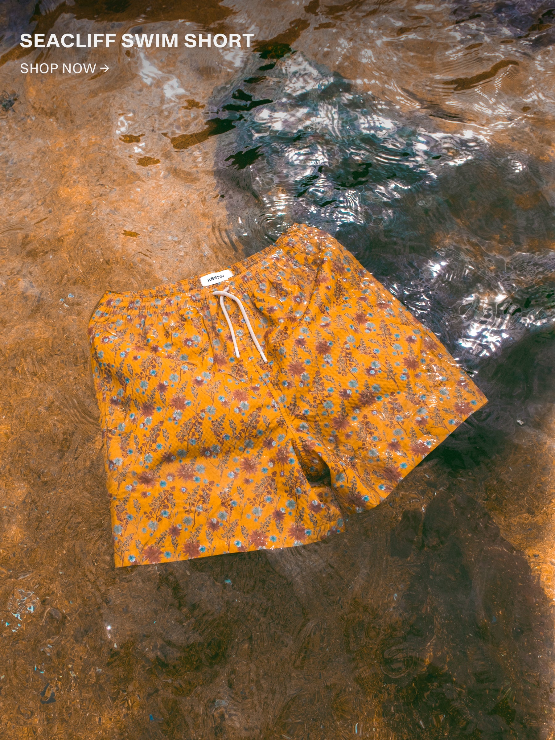 A pair of men's yellow swim shorts, floating in the ocean.