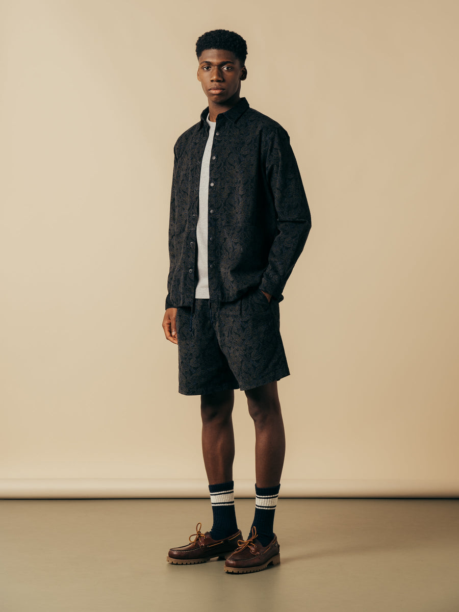 A model wearing a matching jacket and shorts from KESTIN.
