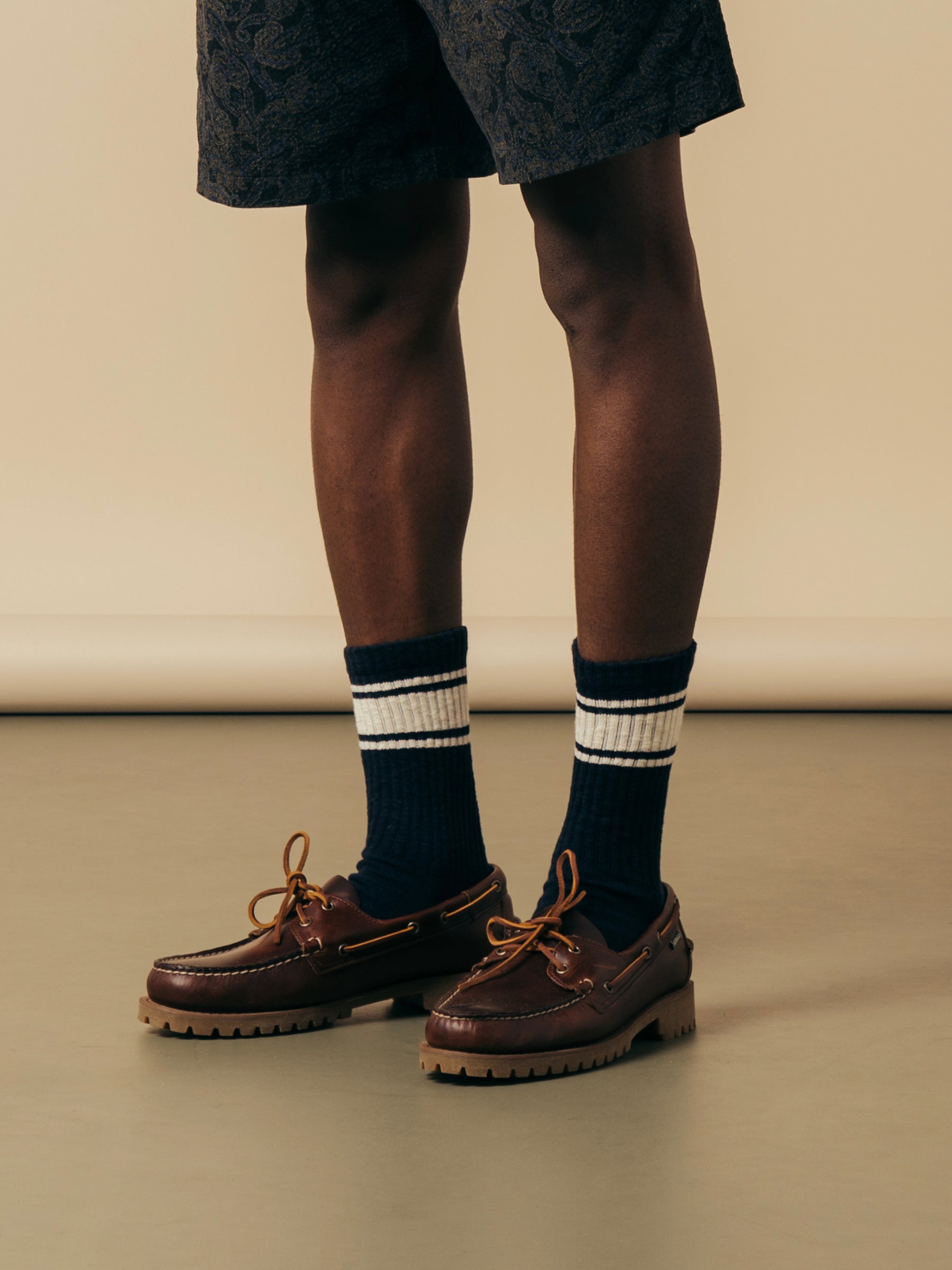 A man wearing made in Scotland socks and Sebago boat shoes.