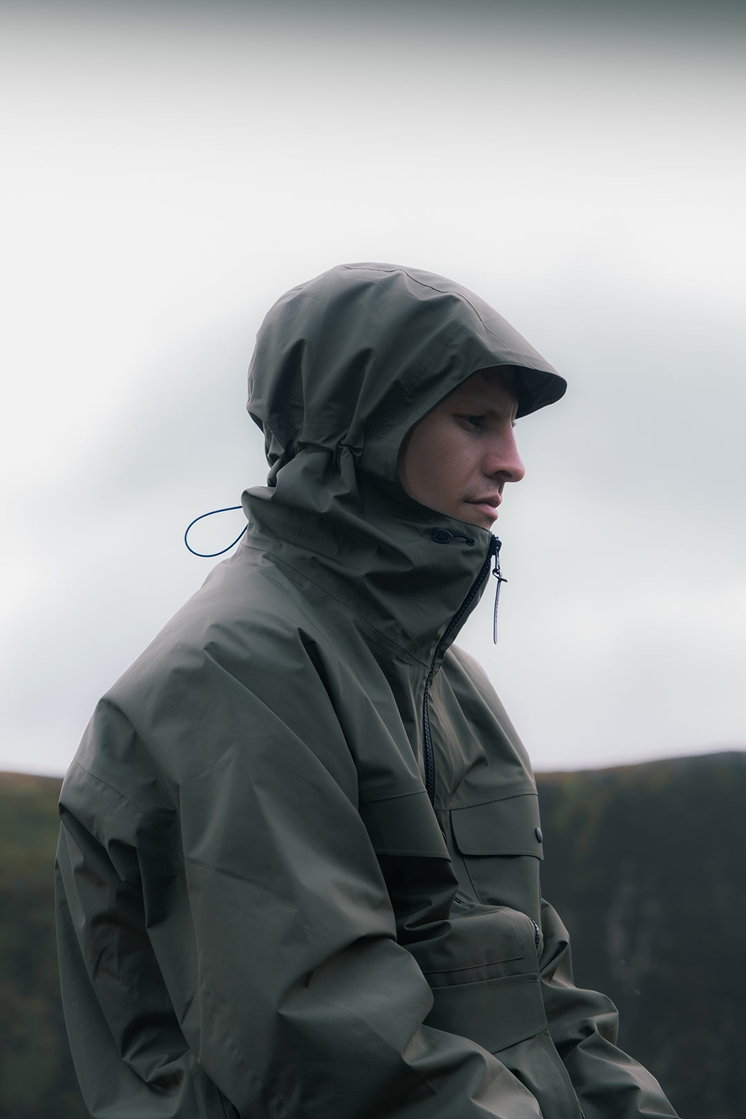 A man wearing a waterproof shell jacket by KESIN whilst hiking in Scotland