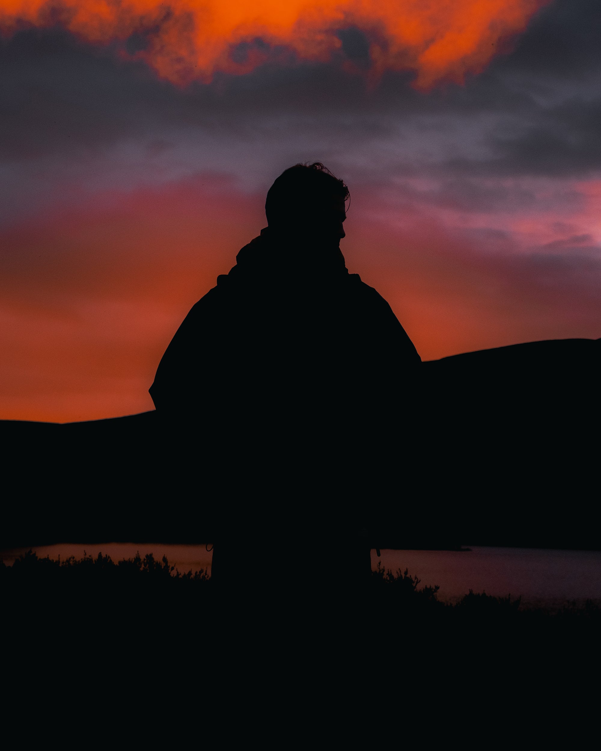 The silhouette of a man watching the sunrise in Scotland's Cairngorms.