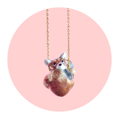 Red Panda Necklace on a pale pink background