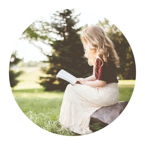 Lady sitting in the park reading a book