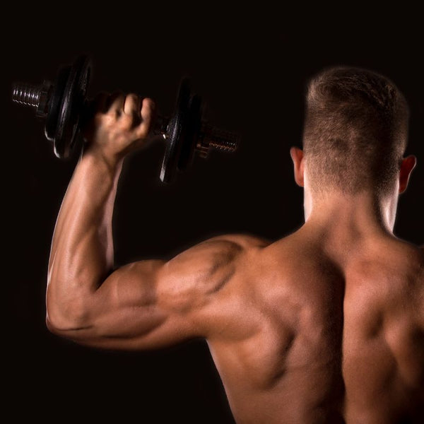 Bodybuilder performing dumbbell shoulder presses